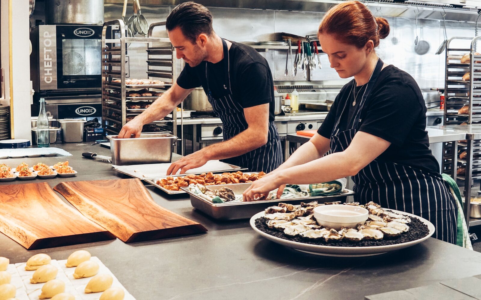 Chefs preparing food in a restaurant kitchen financed through Market Capital Lending